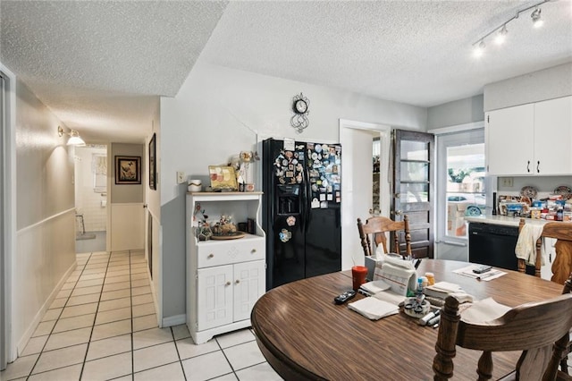 tiled dining space with a textured ceiling