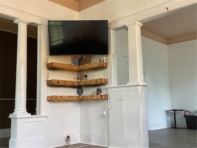 room details featuring decorative columns and hardwood / wood-style floors