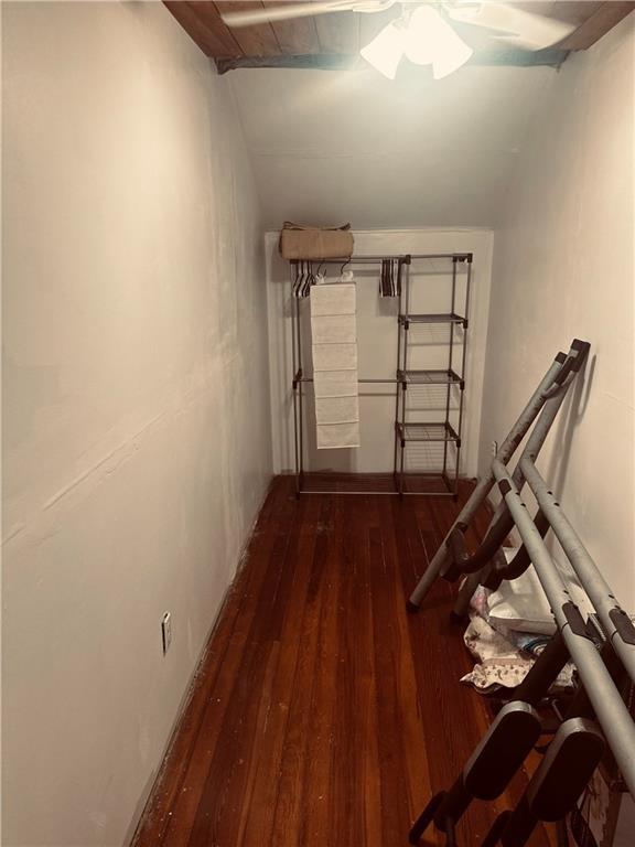 interior space with vaulted ceiling and dark wood-type flooring