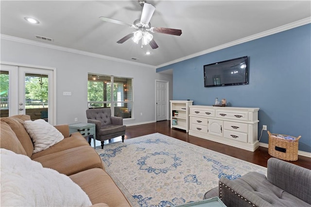 living room with dark hardwood / wood-style floors, ceiling fan, and crown molding