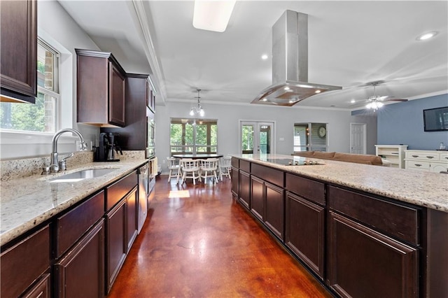 kitchen with light stone countertops, decorative light fixtures, sink, island exhaust hood, and black electric stovetop