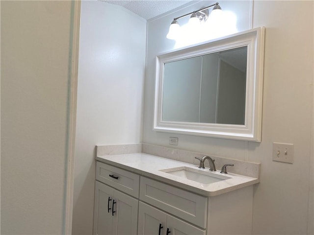 bathroom with oversized vanity and a textured ceiling