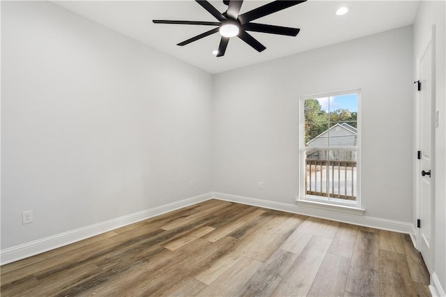 spare room featuring ceiling fan and light hardwood / wood-style flooring