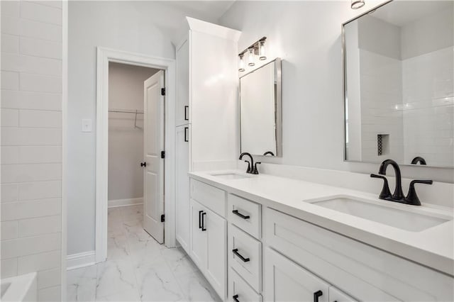 bathroom featuring vanity and a washtub