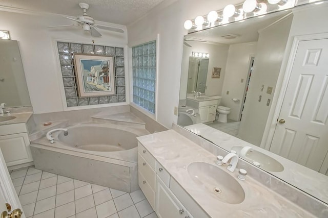 bathroom with tile floors, vanity, a tub, ceiling fan, and a textured ceiling