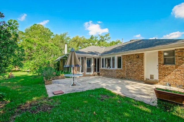 back of house with a patio and a yard