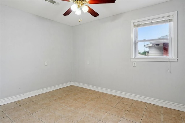 tiled spare room featuring ceiling fan