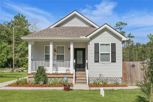 bungalow-style home featuring a front yard and covered porch