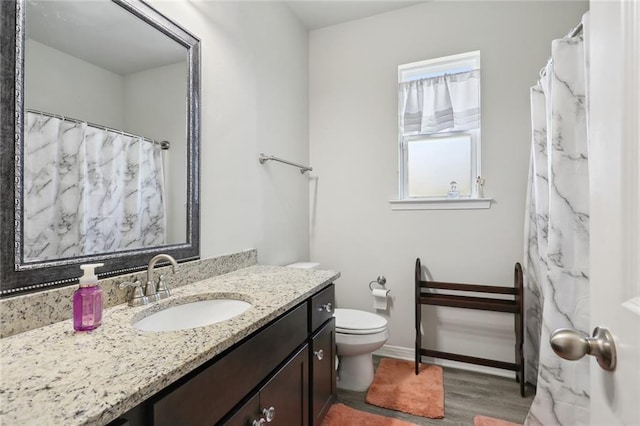 bathroom featuring hardwood / wood-style floors, vanity, and toilet