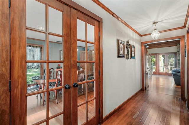 hall with wood-type flooring, french doors, and crown molding