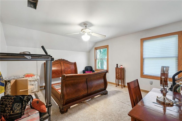 carpeted bedroom with vaulted ceiling and ceiling fan