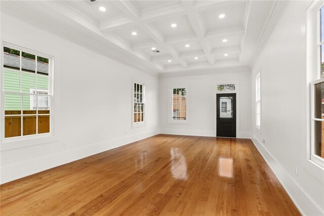 foyer featuring beam ceiling, light hardwood / wood-style floors, ornamental molding, and coffered ceiling