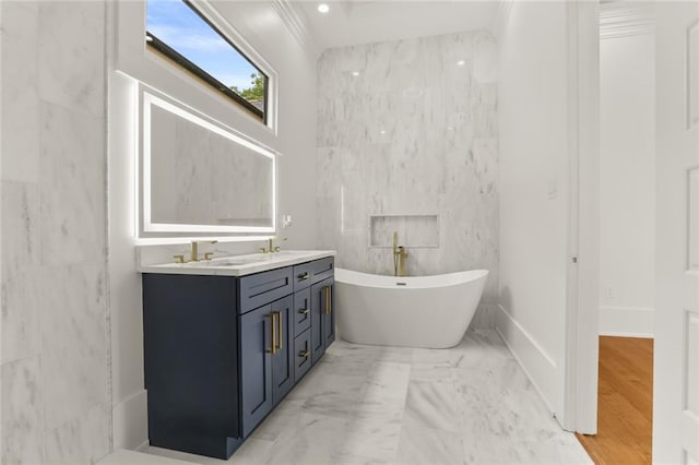 bathroom with a washtub, vanity, and tile walls