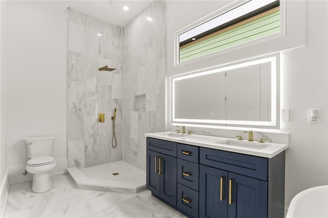 bathroom featuring a tile shower, vanity, and toilet