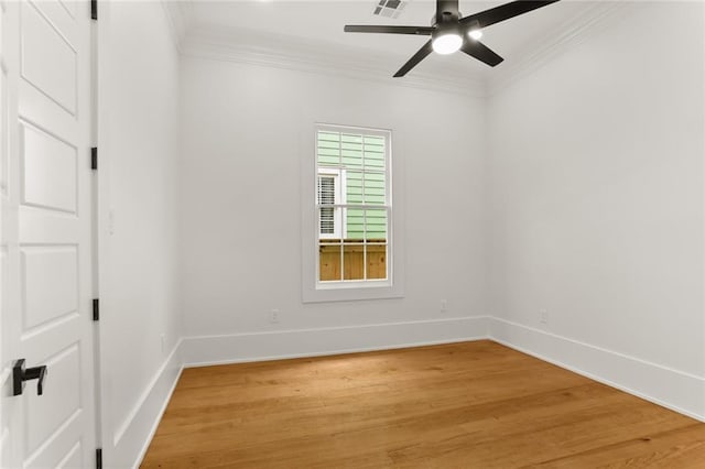 empty room featuring ceiling fan, ornamental molding, and wood-type flooring