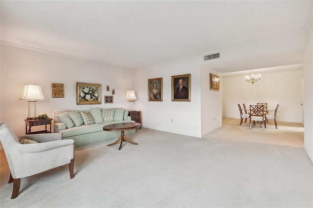 carpeted living room featuring a chandelier