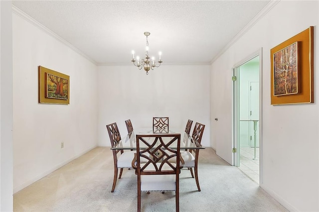 dining space with ornamental molding, light colored carpet, and a chandelier