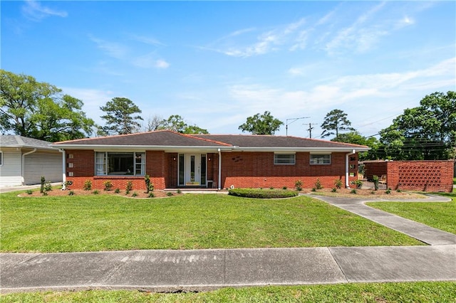 ranch-style home with french doors and a front lawn