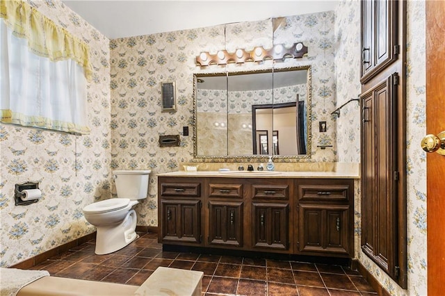 bathroom featuring toilet, tile flooring, and vanity