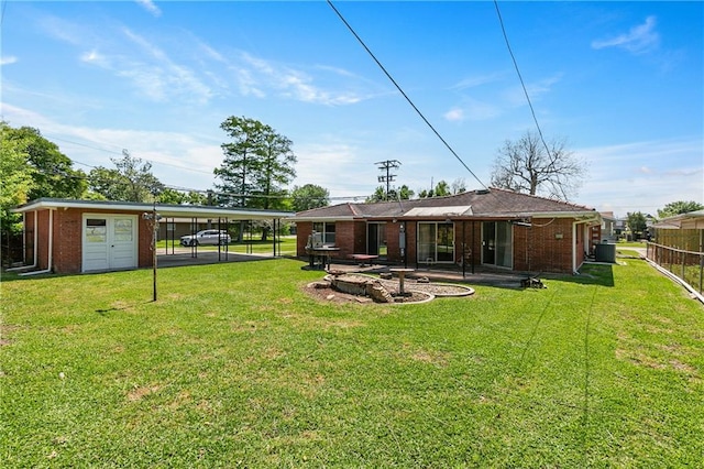 back of house featuring a lawn, a garage, and a patio area