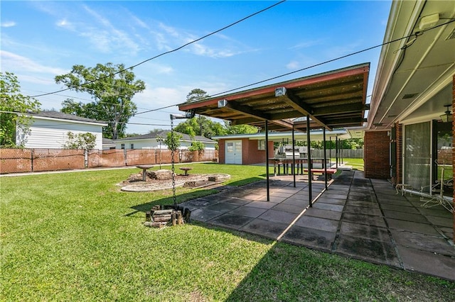 view of yard featuring a patio and a shed