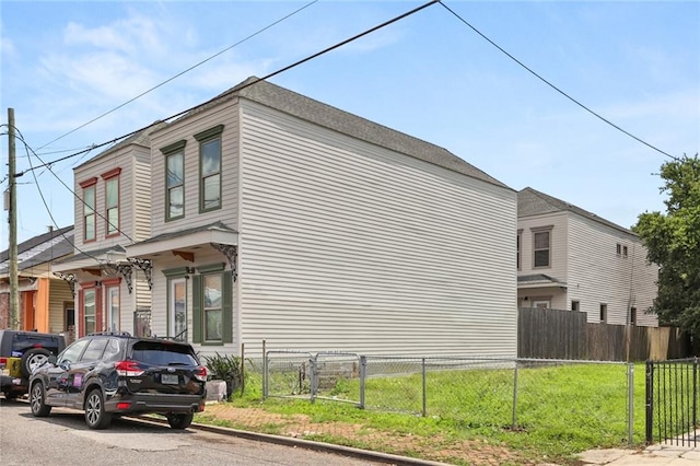 view of side of property with a lawn