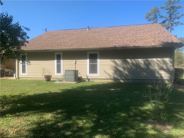 rear view of property featuring a lawn