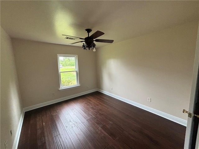 empty room with ceiling fan and dark hardwood / wood-style flooring