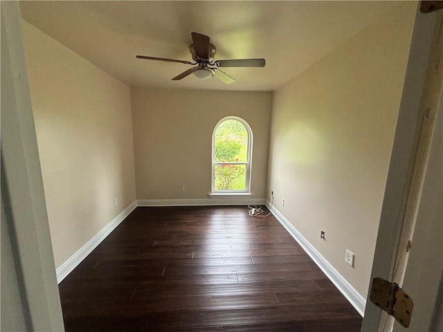 empty room featuring ceiling fan and dark wood-type flooring