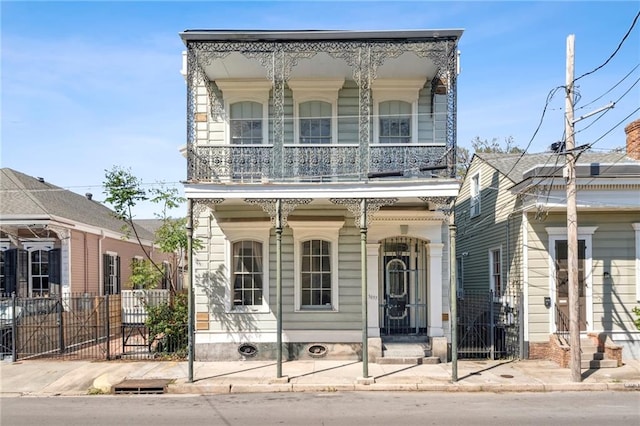 view of front of property featuring covered porch and a balcony