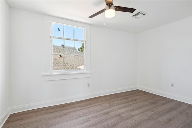 empty room featuring ceiling fan and hardwood / wood-style flooring