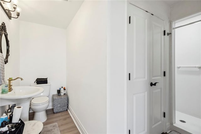 bathroom featuring hardwood / wood-style flooring and toilet