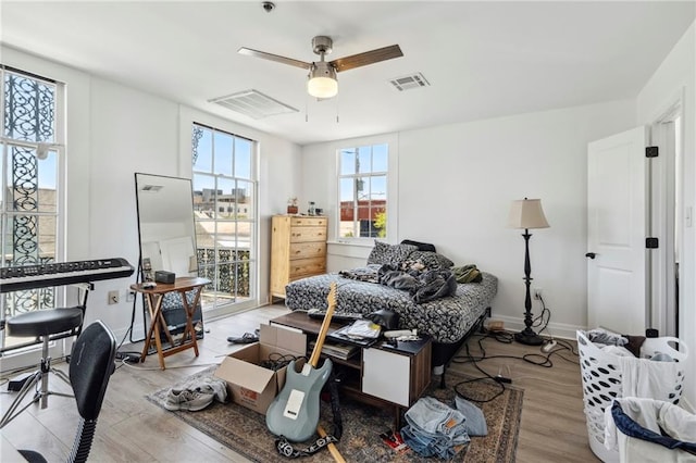 living room with light hardwood / wood-style floors and ceiling fan