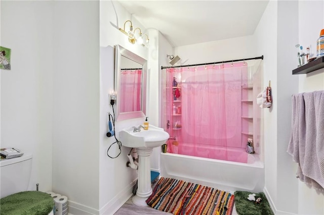 bathroom with shower / tub combo and toilet