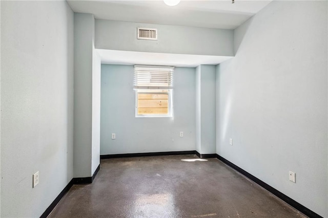 empty room with concrete flooring