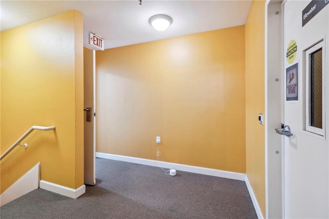 empty room with dark colored carpet