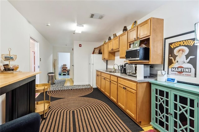 kitchen featuring sink and white refrigerator