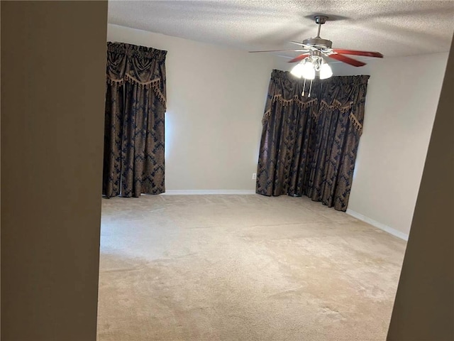 spare room with ceiling fan, carpet flooring, and a textured ceiling