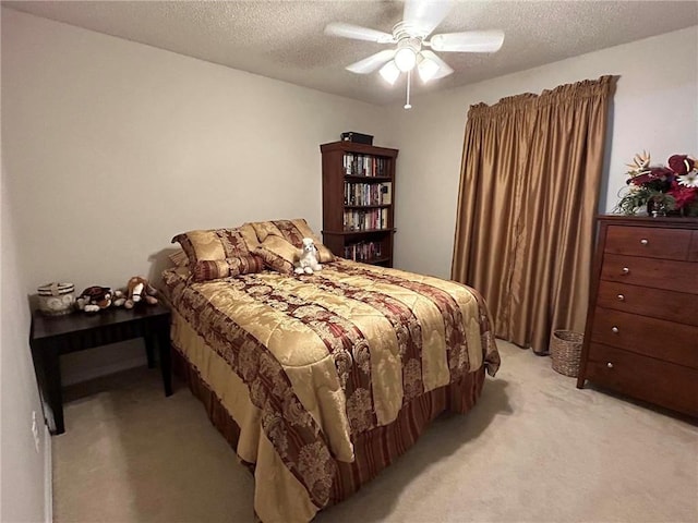 bedroom with a textured ceiling, ceiling fan, and carpet flooring