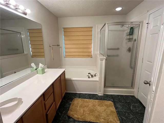 bathroom featuring a textured ceiling, oversized vanity, tile floors, and shower with separate bathtub