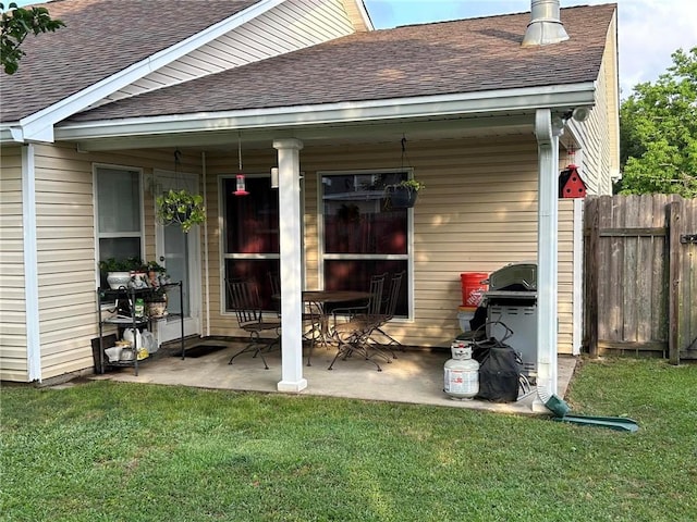 exterior space with a patio and a lawn