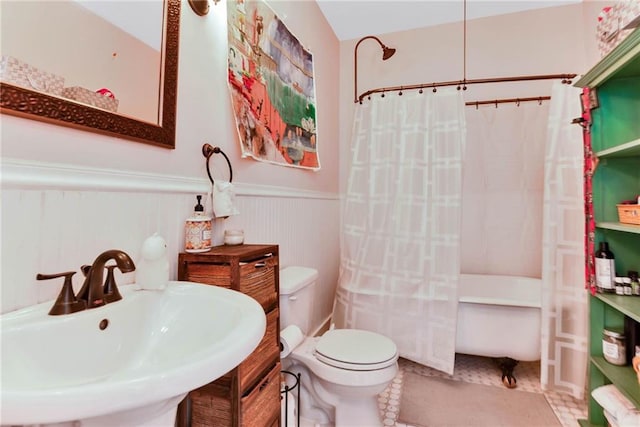 bathroom with toilet, tile floors, and sink