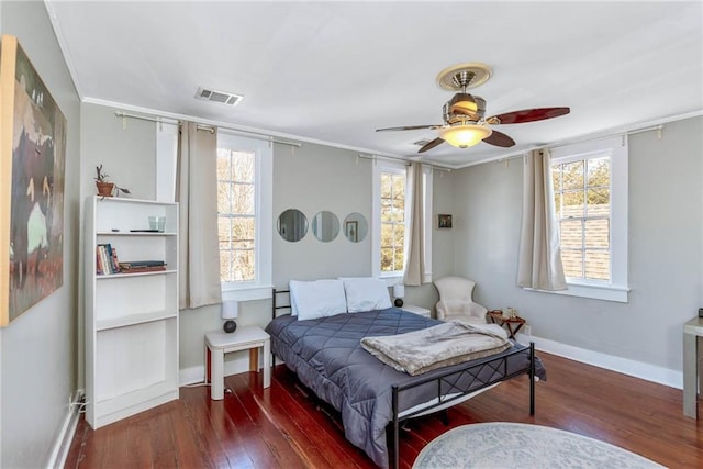 bedroom featuring hardwood / wood-style floors, ceiling fan, and ornamental molding