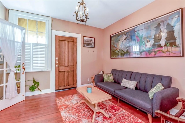 living room with a chandelier and hardwood / wood-style floors