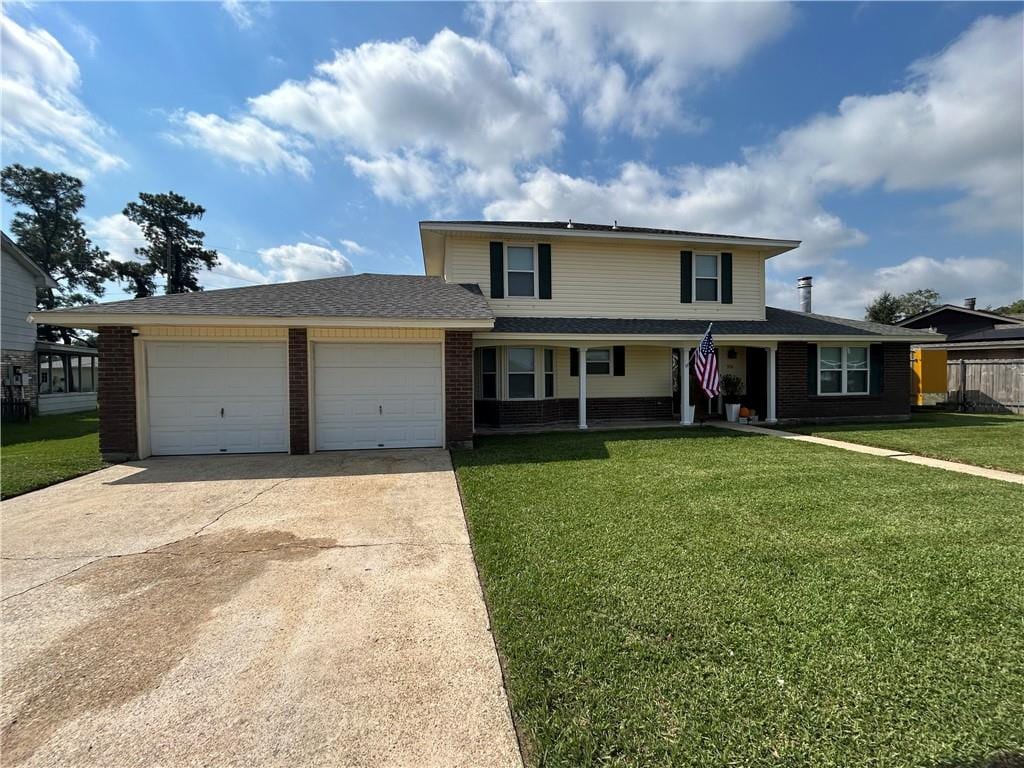 front of property featuring a front lawn and a garage