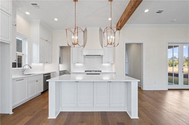 kitchen featuring white cabinets, a center island, sink, and custom exhaust hood