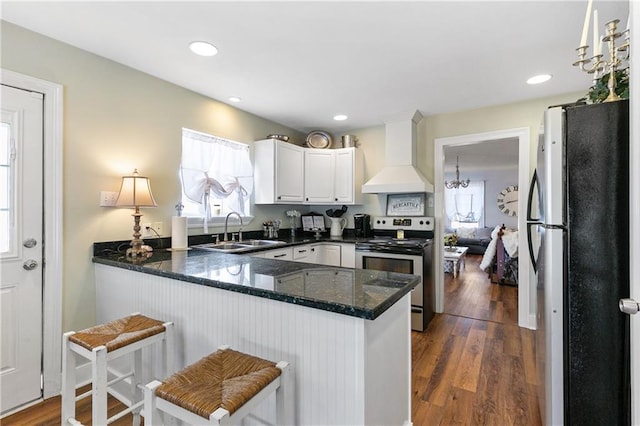 kitchen featuring premium range hood, dark hardwood / wood-style floors, sink, and stainless steel appliances