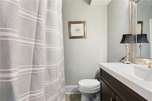 bathroom with toilet, oversized vanity, and tile flooring