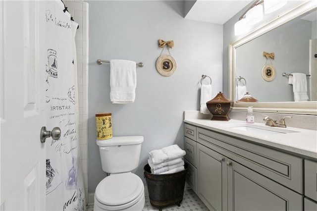 bathroom featuring oversized vanity, toilet, and tile flooring