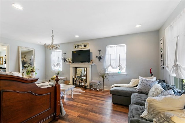 living room featuring dark hardwood / wood-style flooring and an inviting chandelier